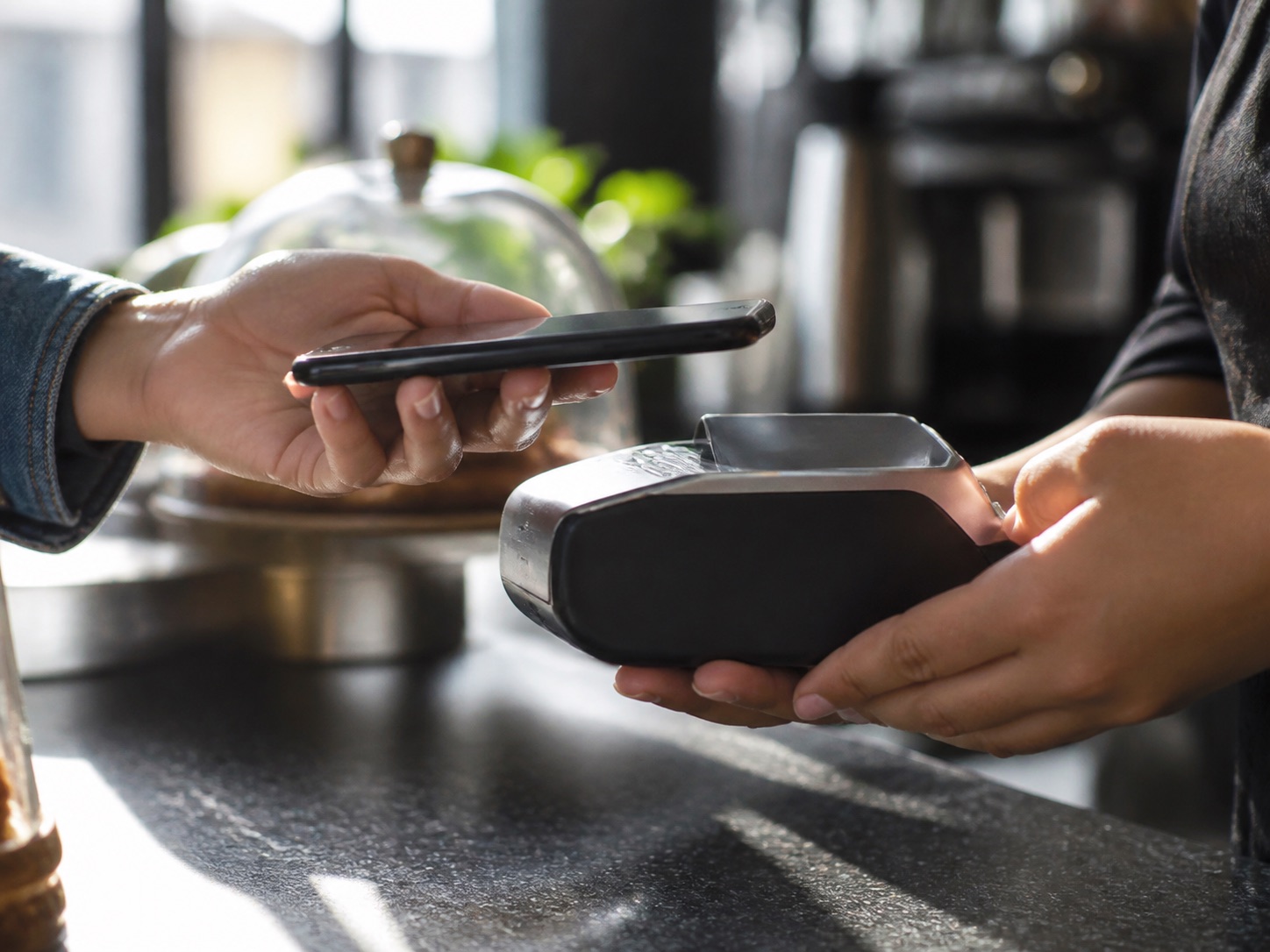 A customer making a contactless mobile payment