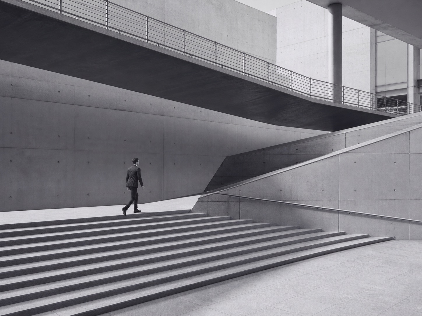 A professional moving through modern architectural steps and bridges